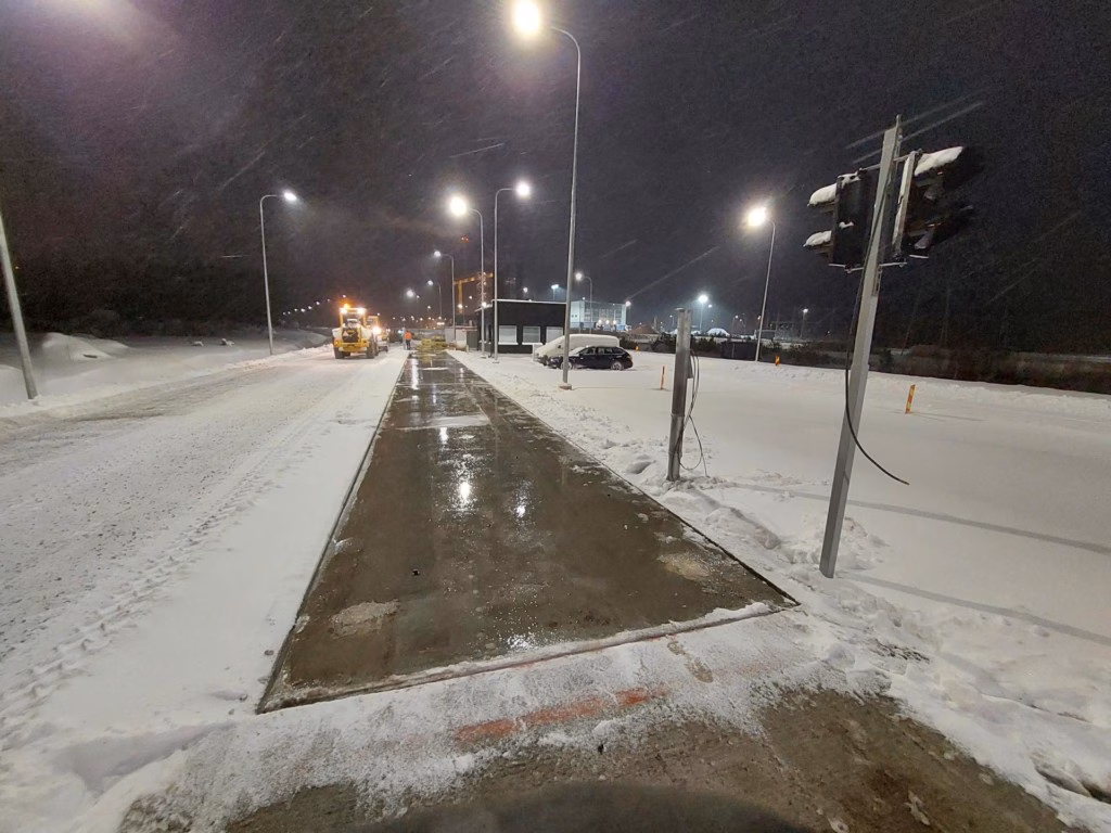 Eine winterliche Straße mit Schneeverwehungen verdeutlicht die extremen Witterungsbedingungen für industrielle Lkw-Waagen.